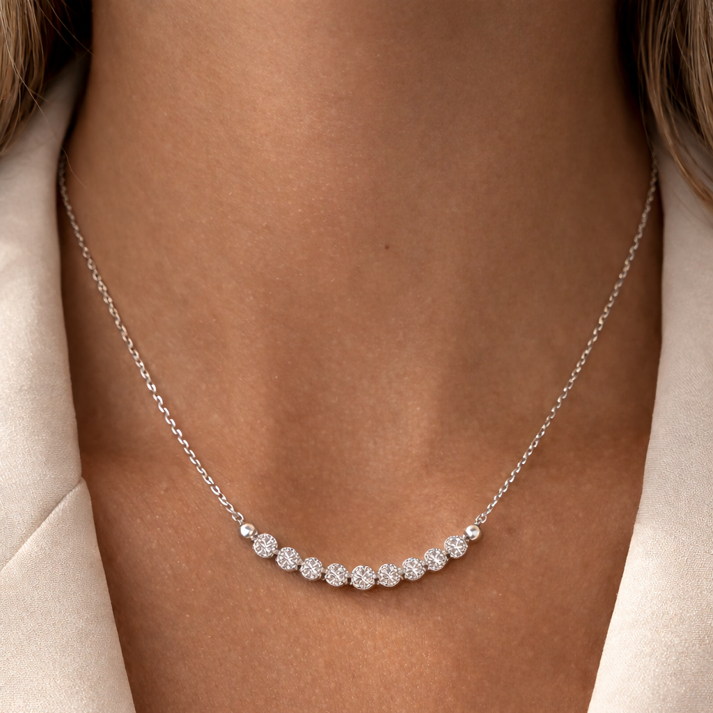 Silver necklace with small diamonds on a person's neck
