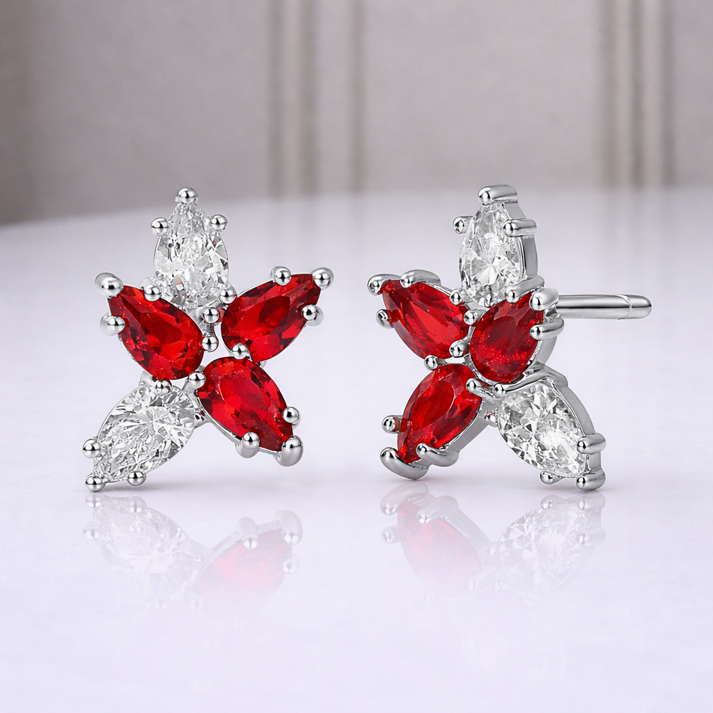 Red butterfly-shaped earrings with clear stones on a white background