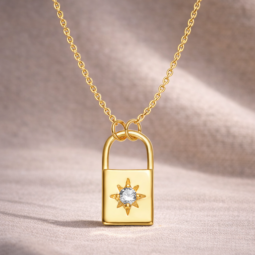 Gold lock-shaped pendant with a diamond on a beige background