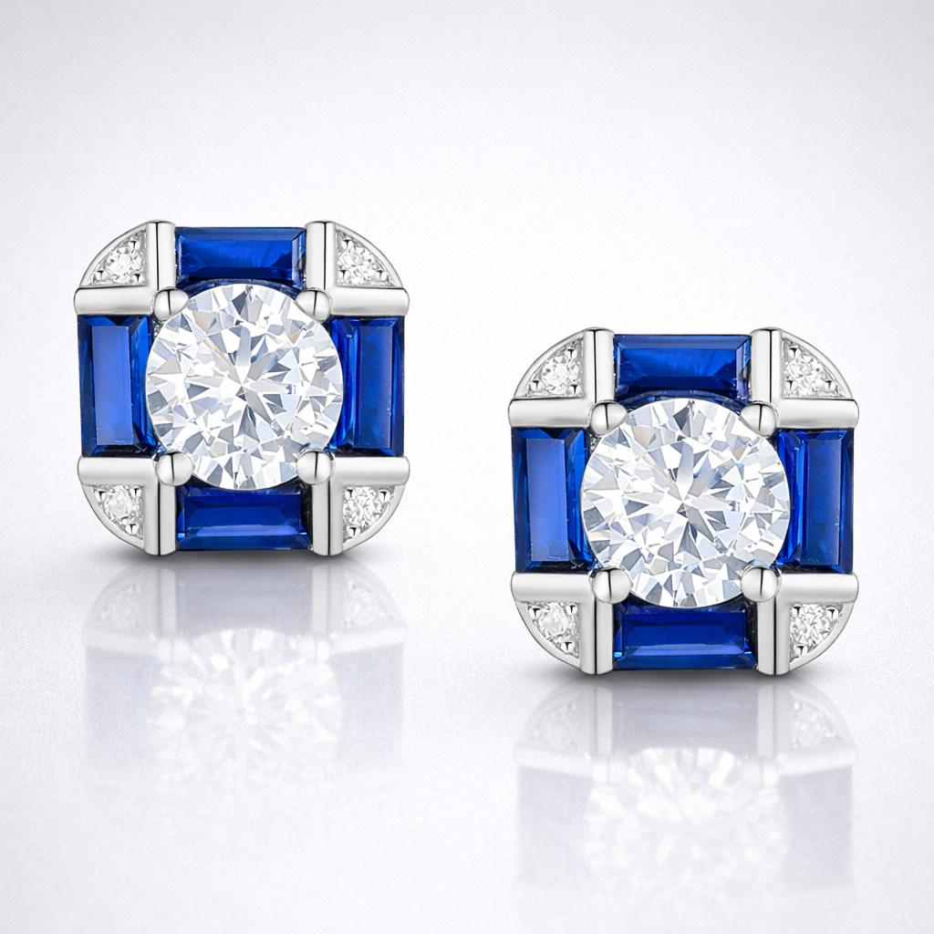 Pair of earrings with blue gemstones and clear stones on a white background