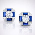Pair of earrings with blue gemstones and clear stones on a white background