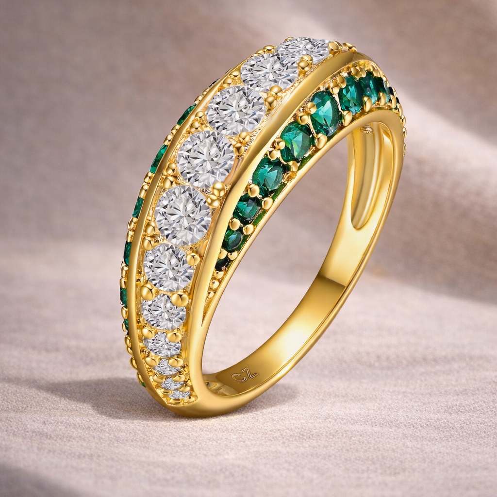 Gold ring with diamonds and emeralds on a beige background