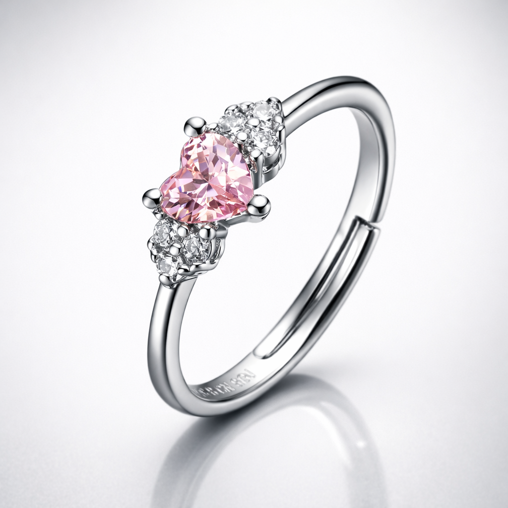 Silver ring with a pink heart-shaped gemstone on a white background