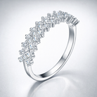 Silver ring with diamond accents on a light gray background