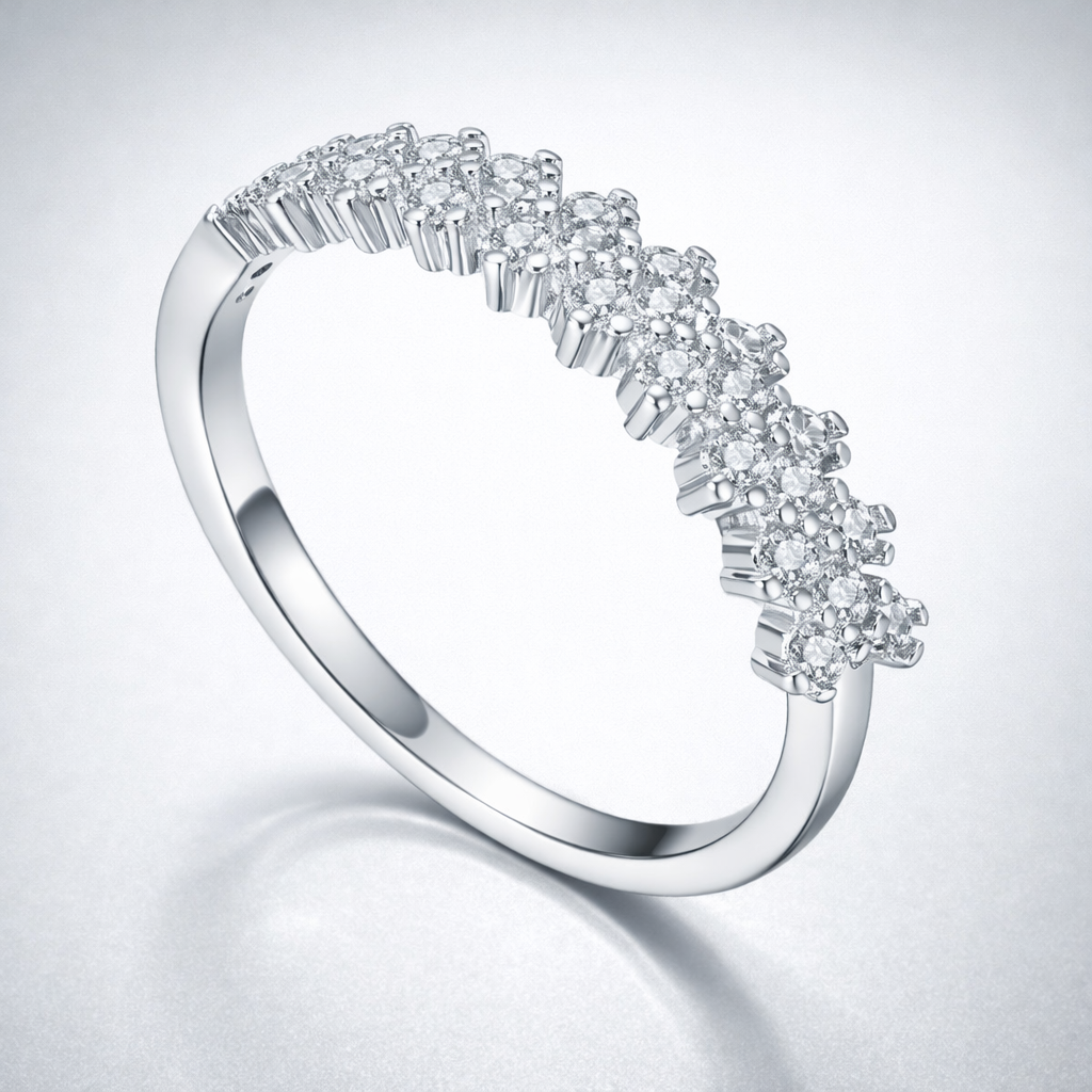 Silver ring with diamond accents on a light gray background