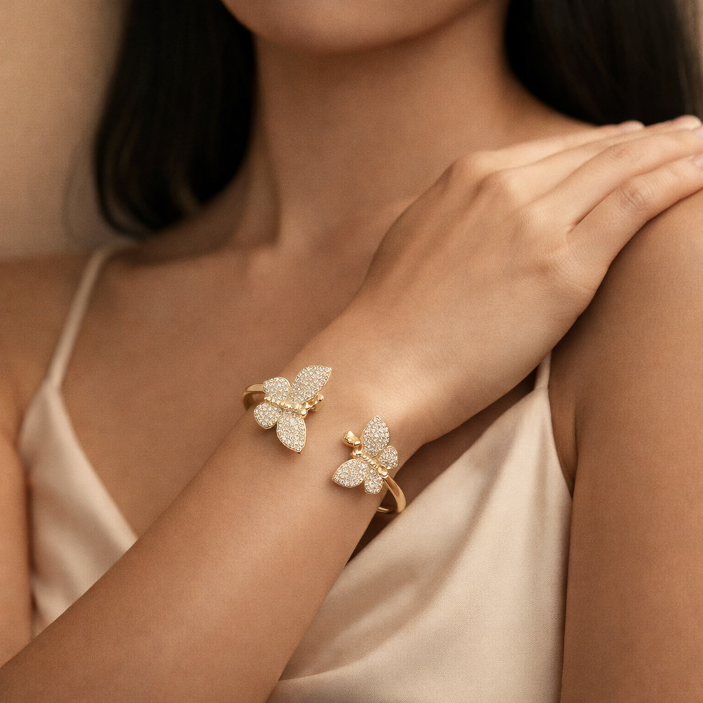 Butterfly-shaped diamond bracelet on a woman's wrist with a neutral background