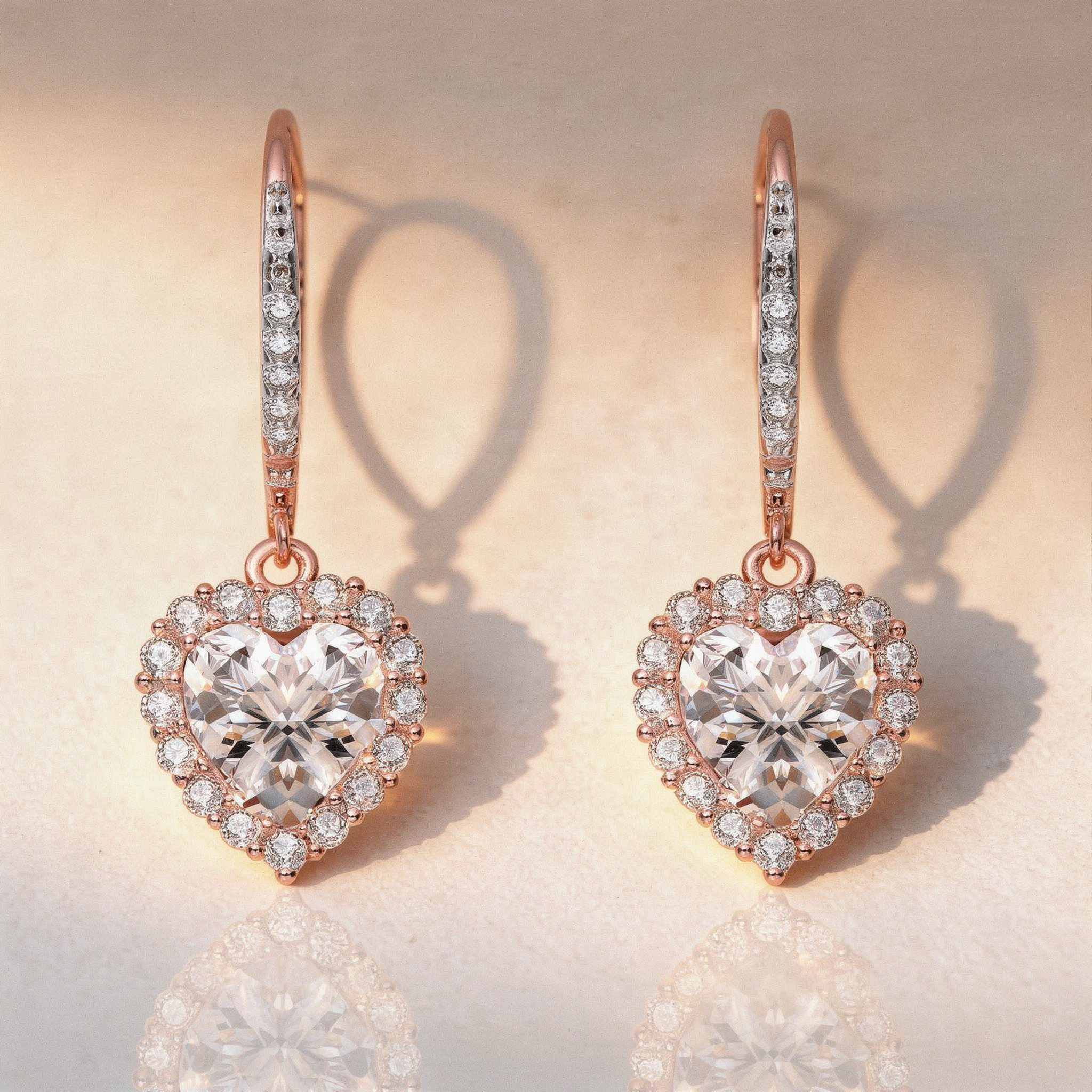 Heart-shaped diamond earrings with rose gold accents on a soft beige background