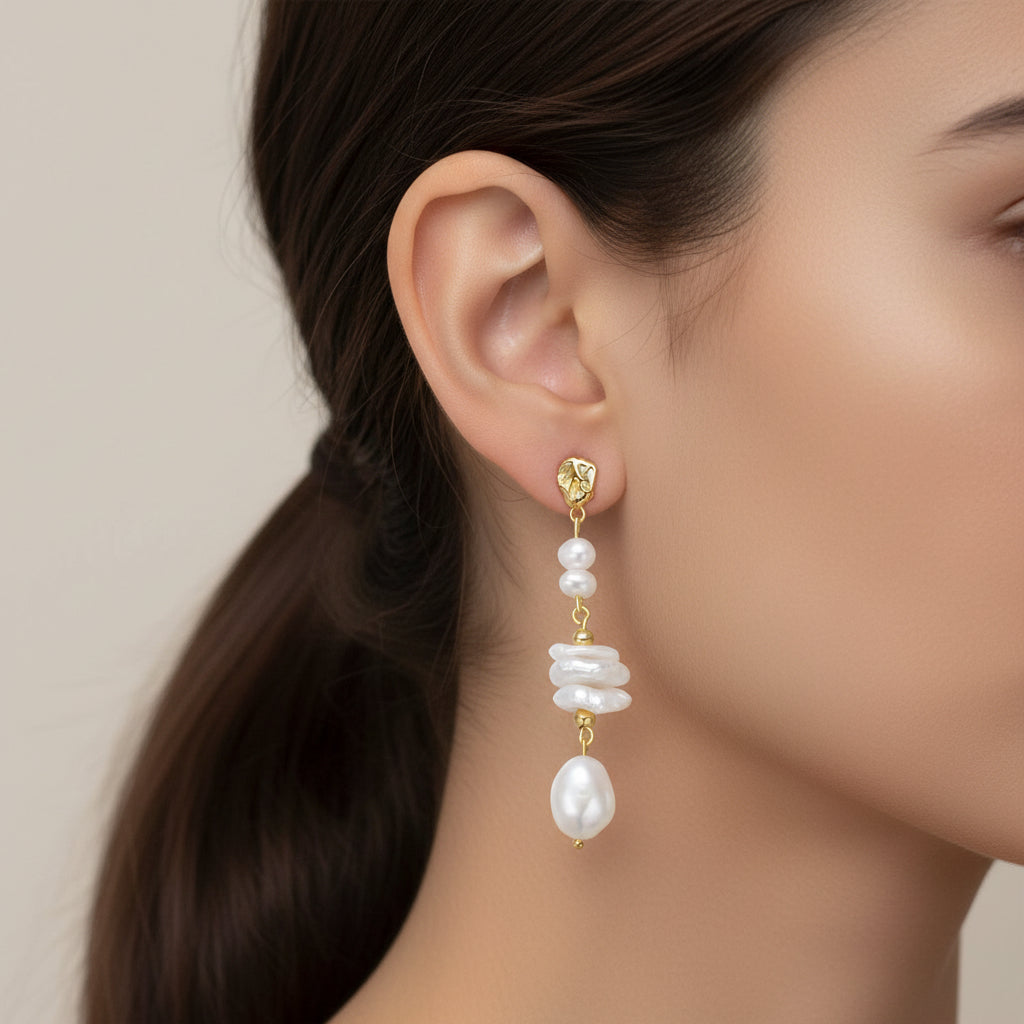 Pearl earring worn by a model with a neutral background
